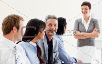 Glowing businesswoman presenting to her team