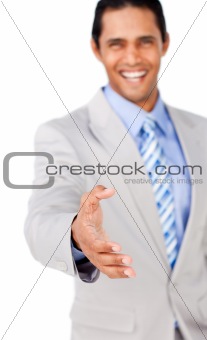 Confident businessman reaching out to shake hands