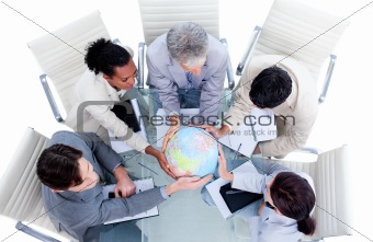 Serious international business team holding a terrestrial globe