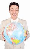 Assertive male executive holding a terrestrial globe 