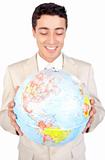 Positive male executive looking at a globe 