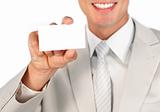Close-up of a businessman holding a white card isolated on a white background