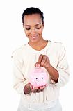 Young Afro-american businesswoman saving money in a piggybank
