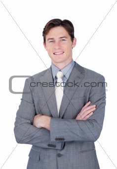 Self-assured businessman standing with folded arms 