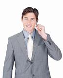 Smiling young businessman using headset 