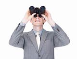 Young businessman looking up through binoculars 