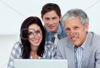 Charismatic business people working at a computer 