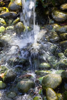 Water splashing down on boulders