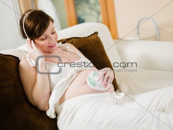 pregnant woman listening to her baby heartbeat