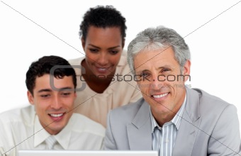 Multi-ethnic business people working at a computer 