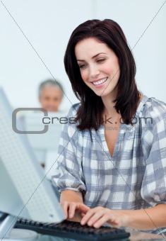 Charming businesswoman working at a computer