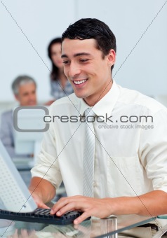 Cheerful businessman working at a computer