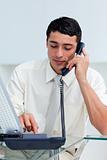 Concentrated Hispanic businessman on phone 
