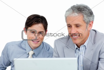 Concentrated business co-workers using a laptop 