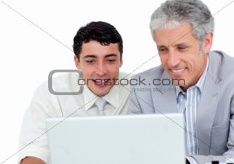 Assertive business co-workers using a laptop