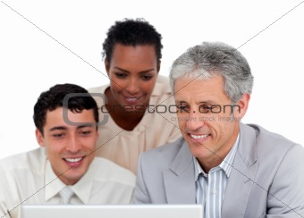 Confident business co-workers using a laptop