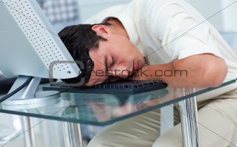 Tired businessman sleeping at his desk 