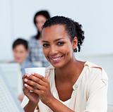 Glowing businesswoman drinking a coffee at her desk