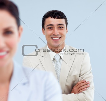 Self-assured businessman standing with folded arms 