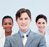 Smiling business people standing with folded arms 