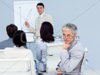 Charming businessman looking at the camera at a conference