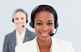Ethnic businesswoman and her colleague with headset on