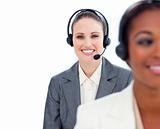 Portrait of young businesswoman and her colleague with headset o