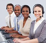 Multi-ethnic business people with headset on in a call center