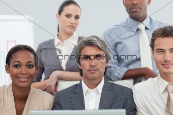Cocentrated diverse business people working at a laptop