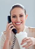 Caucasian businesswoman on phone drinking a coffee