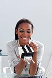 Afro-american businesswoman holding a business card holder 