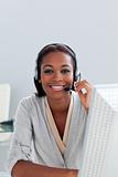 Smiling ethnic customer service agent with headset on 