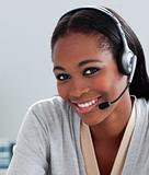 Delighted Afro-american businesswoman using headset 