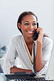 Bright Afro-american businesswoman talking on a phone 