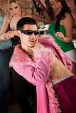 Handsome Asian man in fluffy pink coat at a 1970's disco party