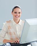 Positive businesswoman working at a computer 