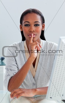 Charming businesswoman asking for silence at her desk 