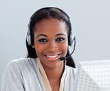 Charismatic businesswoman using headset at her desk