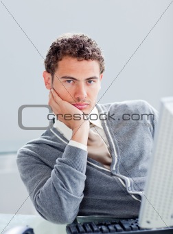 Portrait of a young businessman getting bored at work