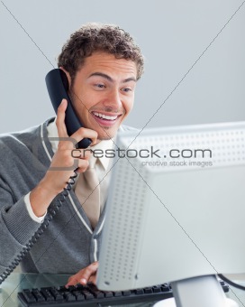 Charming businessman on phone at his desk 