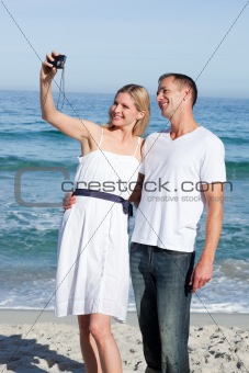 Loving couple having fun at the shore line at the beach