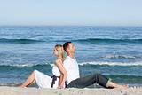 Loving couple sitting on the sand 