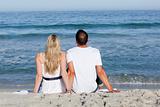 Loving couple having fun at the shore line at the beach