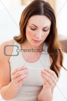Pensive woman finding out results of a pregancy test