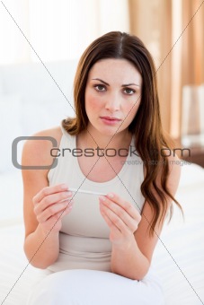 Upset woman finding out results of a pregancy test