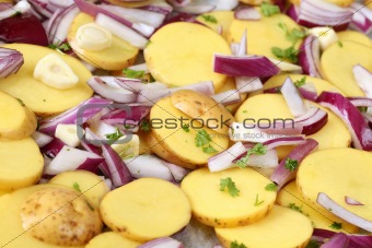 Raw potatoes with red onion, garlic and parsley