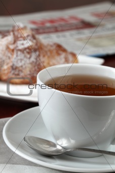 Tea, croissant and newspaper