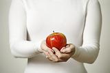 Female hands holding apple
