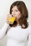 Beautiful female drinking orange juice