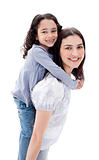Cheerful mother giving her daughter piggyback ride 